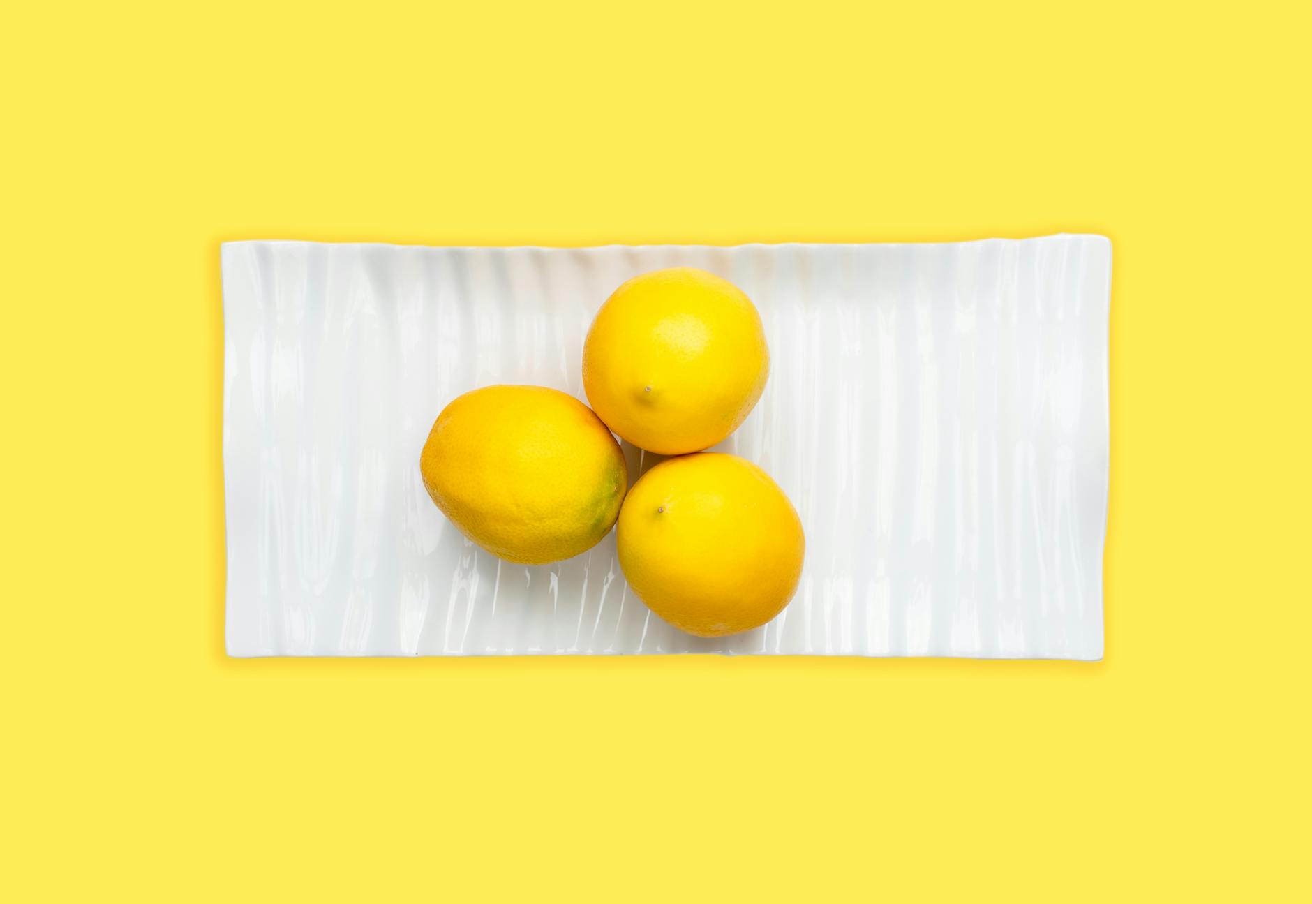 A colorful collection of vibrators and clitoral toys displayed on a bright yellow background